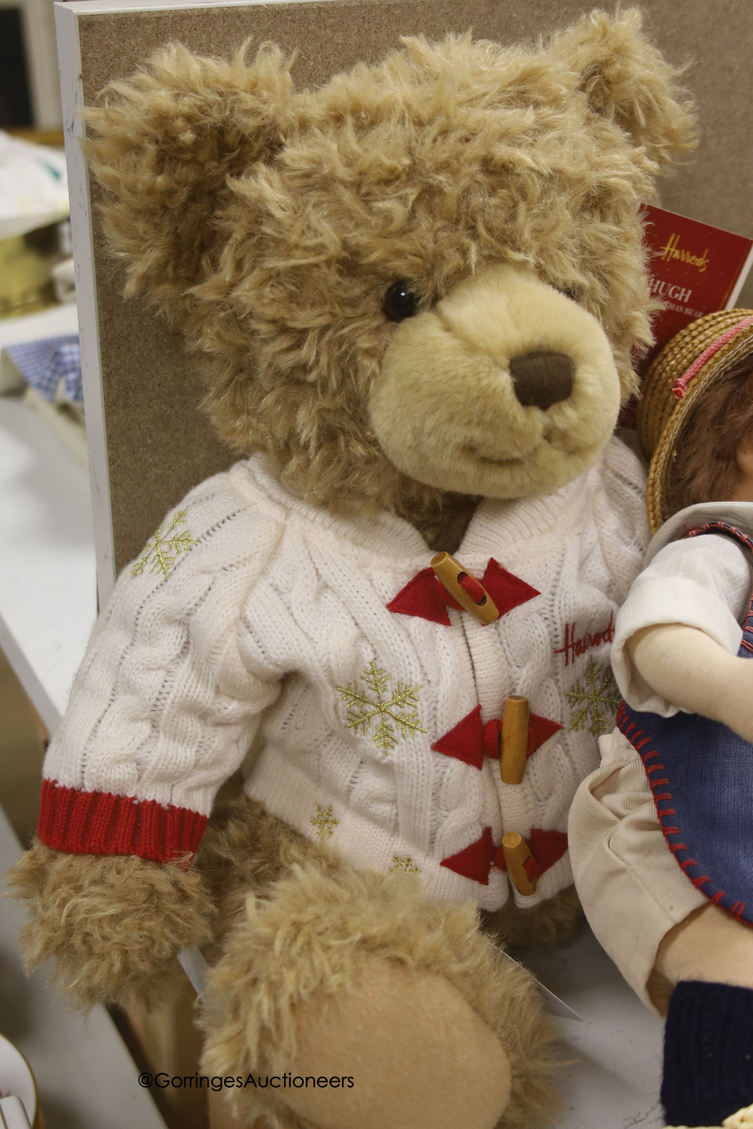 A modern Kathe Kruse doll with Burlington Berties cot and modern china baby doll and Harrods bear